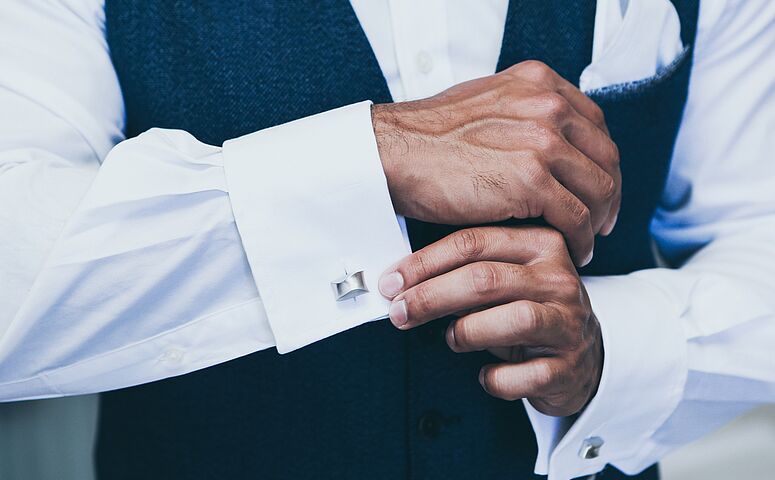 cufflinks-on-mens-white-shirt-and-dark-blue-waistcoat