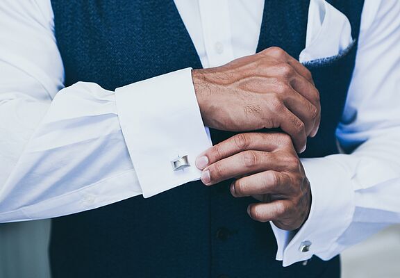 cufflinks-on-mens-white-shirt-and-dark-blue-waistcoat